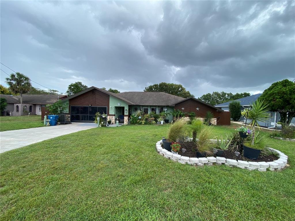 4100 Montano Avenue Spring Hill, FL 34609 - Photo 57 of 59 a front view of a house with a yard