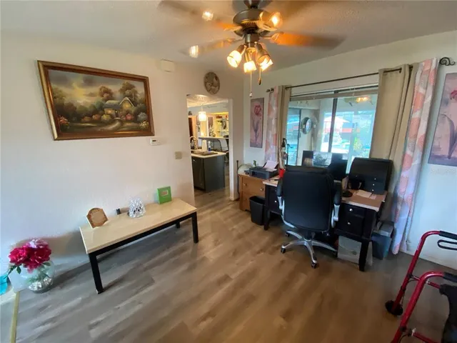 a living room with furniture a chandelier and a flat screen tv