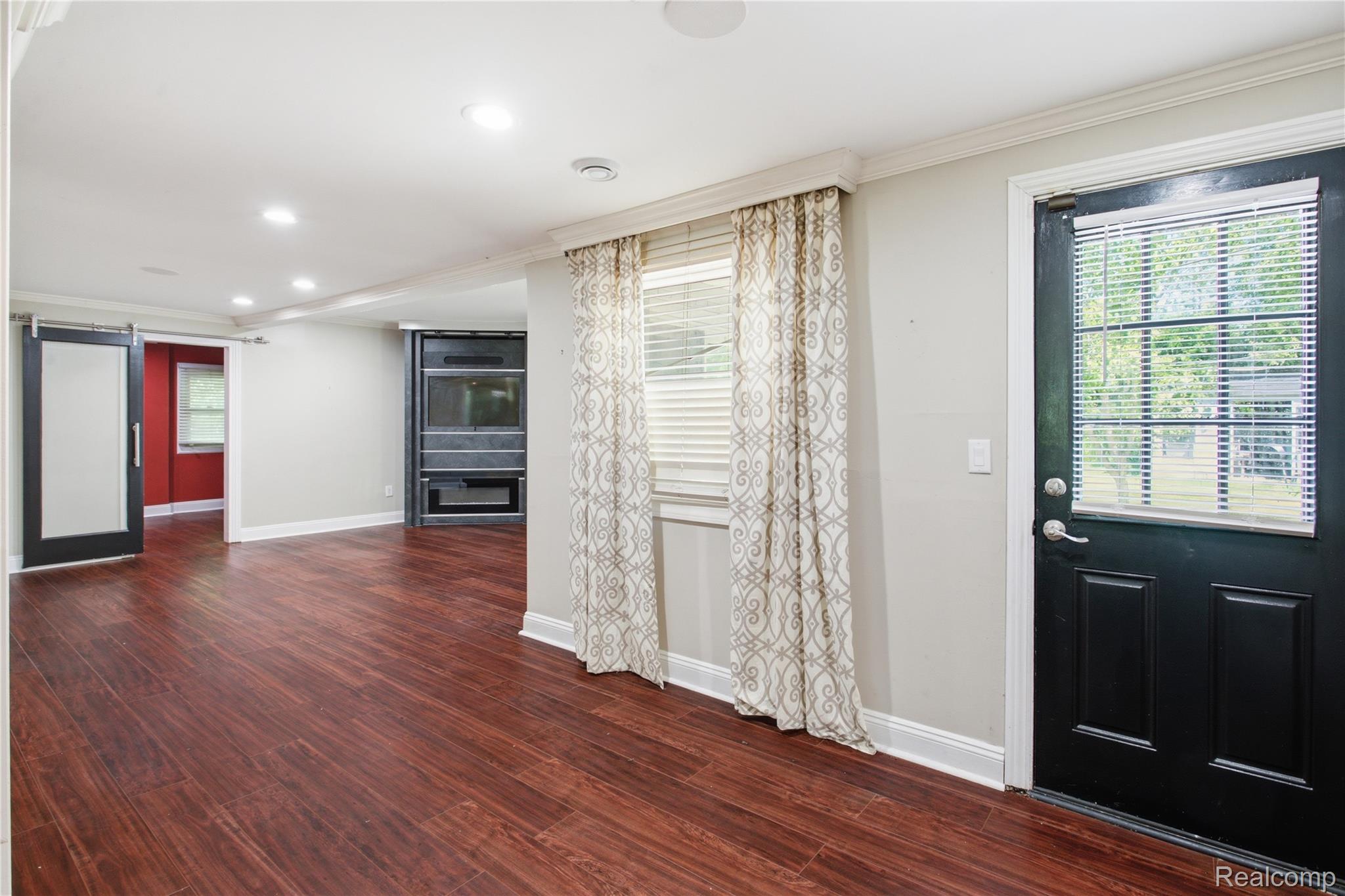 3812 Terrybrook Road West Bloomfield, MI 48322 - Photo 15 of 43 Spacious living area featuring rich wood-finish flooring, recessed lighting, and a built-in media center