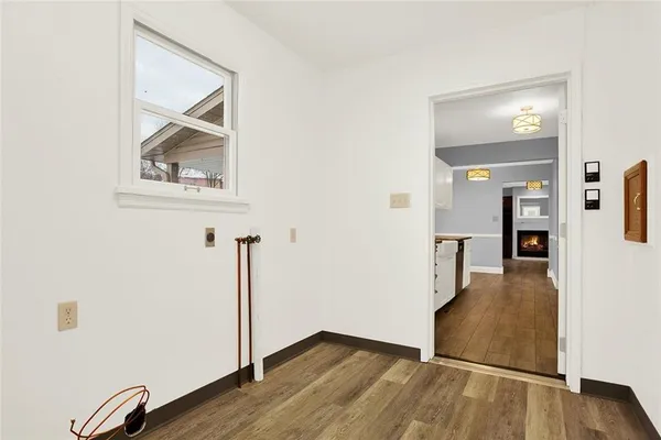 a kitchen with granite countertop a stove a sink and a refrigerator