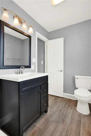 an empty room with chandelier fan and windows