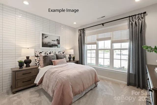 a bedroom with bed tv and window