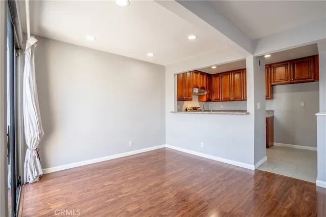 an empty room with wooden floor and a window