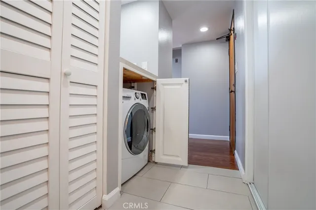 a view of a hallway with washer and dryer