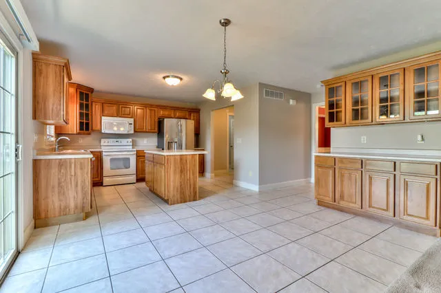 a kitchen with stainless steel appliances granite countertop a refrigerator oven a sink and dishwasher