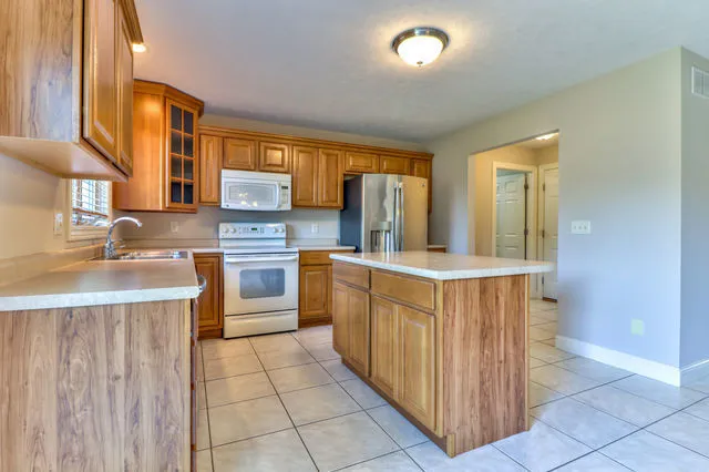 a kitchen with stainless steel appliances a sink and cabinets