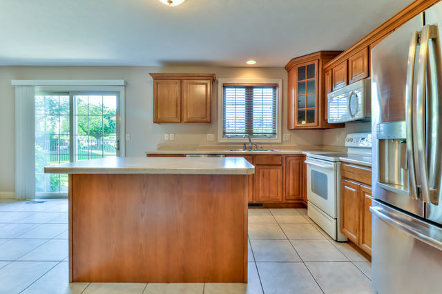 2515 St Andrews Road Urbana, IL 61802 - Photo 15 of 50 a kitchen with stainless steel appliances granite countertop a sink stove and refrigerator
