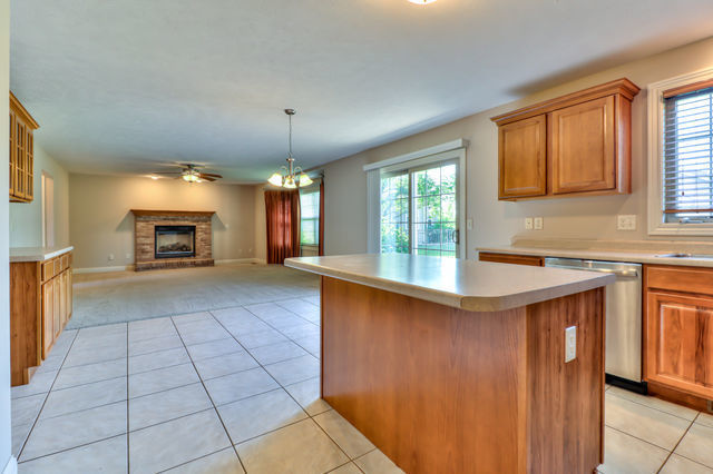 2515 St Andrews Road Urbana, IL 61802 - Photo 16 of 50 a kitchen with granite countertop a stove a sink and a refrigerator