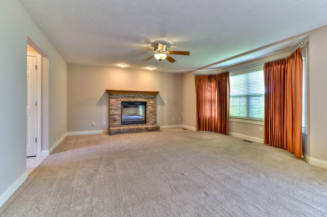 2515 St Andrews Road Urbana, IL 61802 - Photo 17 of 50 an empty room with chandelier fan and windows