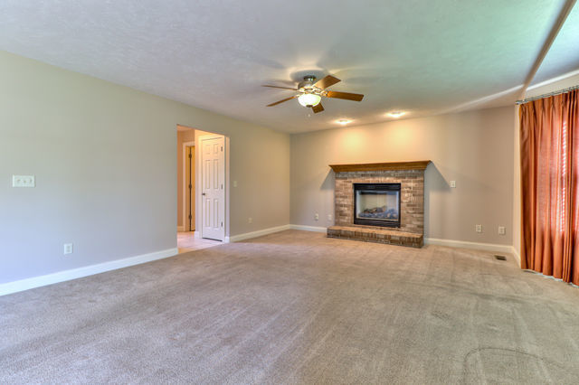 2515 St Andrews Road Urbana, IL 61802 - Photo 18 of 50 a view of an empty room with a fireplace and a window