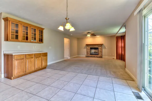 a view of a livingroom with a ceiling fan and window