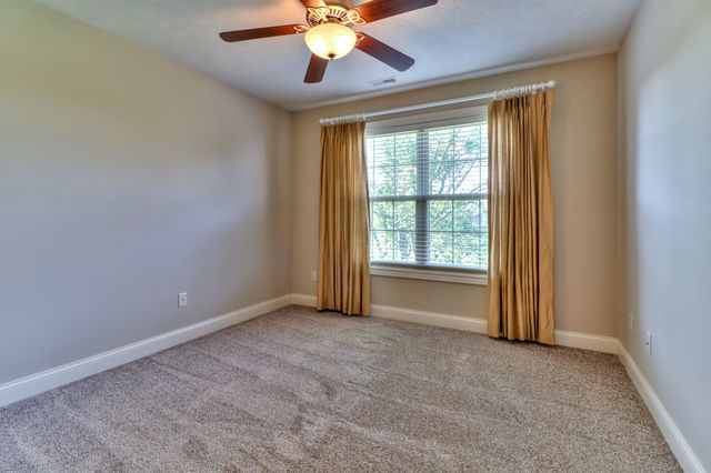 2515 St Andrews Road Urbana, IL 61802 - Photo 32 of 50 an empty room with chandelier fan and windows