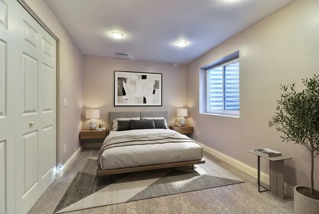 a bedroom with a bed and a potted plant