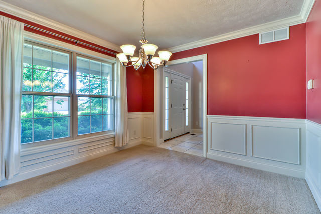 2515 St Andrews Road Urbana, IL 61802 - Photo 6 of 50 a view of a livingroom with a chandelier fan and windows