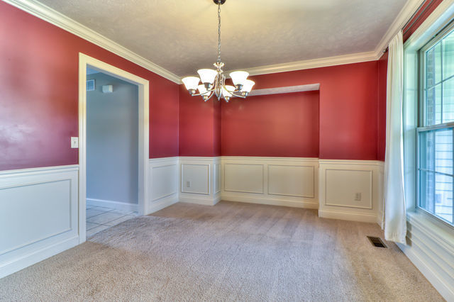 2515 St Andrews Road Urbana, IL 61802 - Photo 7 of 50 a view of a livingroom with a fan a chandelier fan and windows