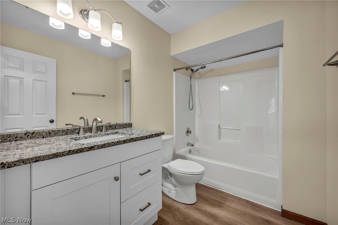 9842 Johnnycake Ridge Road Mentor, OH 44060 - Photo 20 of 40 Bathroom featuring a white vanity with granite-style countertop, a single undermount sink, and brushed nickel hardware