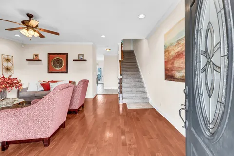 a living room with furniture and a chandelier