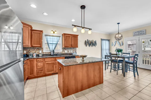 a kitchen with stainless steel appliances granite countertop sink stove and cabinets