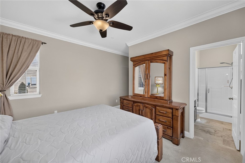 31749 Country View Road Temecula, CA 92591 - Photo 21 of 68 a bedroom with a bed and a chandelier