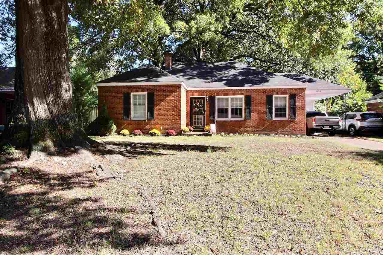 1654 Colonial Road Memphis, TN 38117 - Photo 1 of 14 a front view of a house with a yard covered with snow