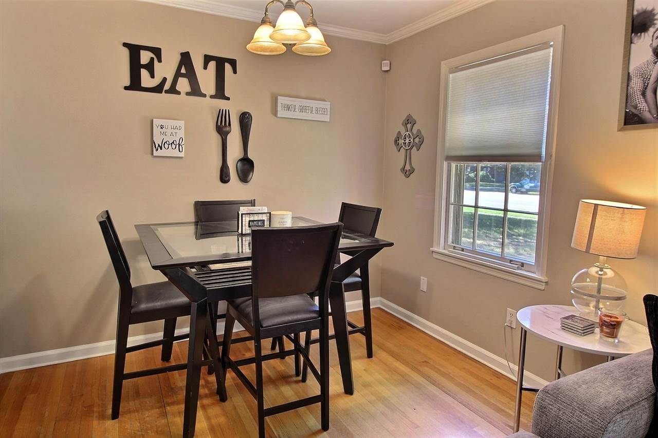 1654 Colonial Road Memphis, TN 38117 - Photo 14 of 14 a view of a dining room with furniture a chandelier and wooden floor