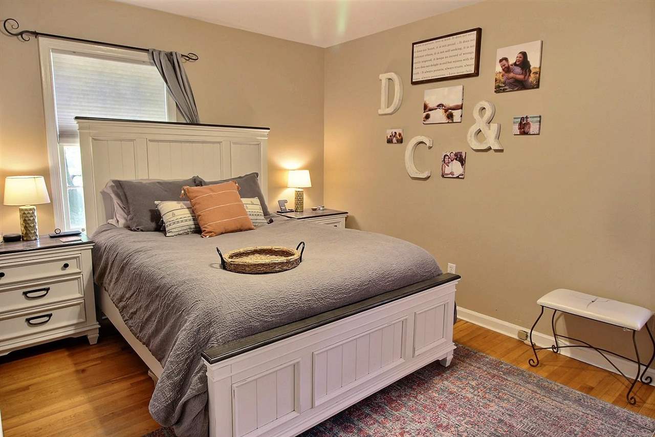 1654 Colonial Road Memphis, TN 38117 - Photo 4 of 14 a bedroom with a bed and a lamp on dresser