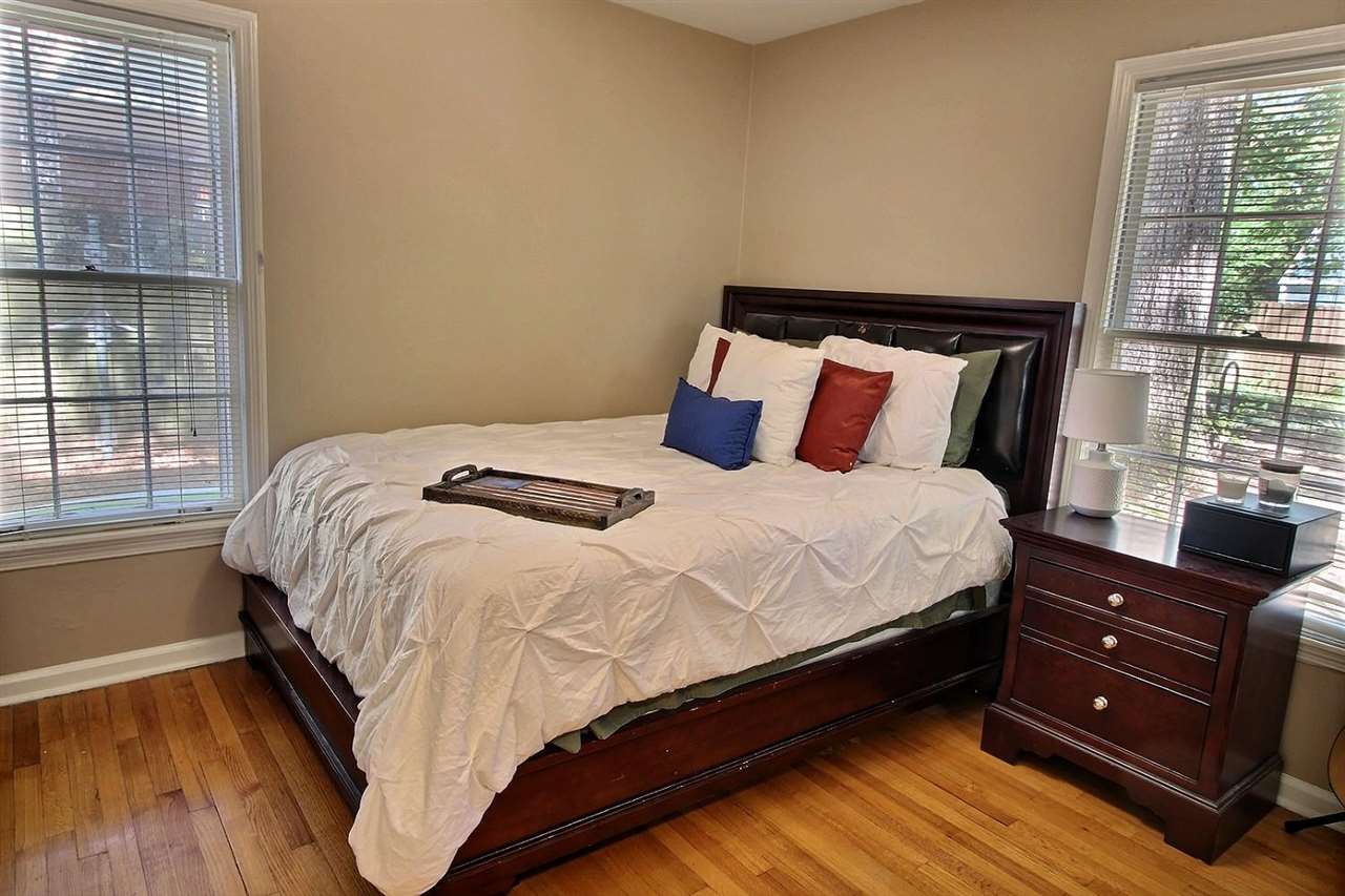 1654 Colonial Road Memphis, TN 38117 - Photo 6 of 14 a bed sitting in a bedroom next to a window