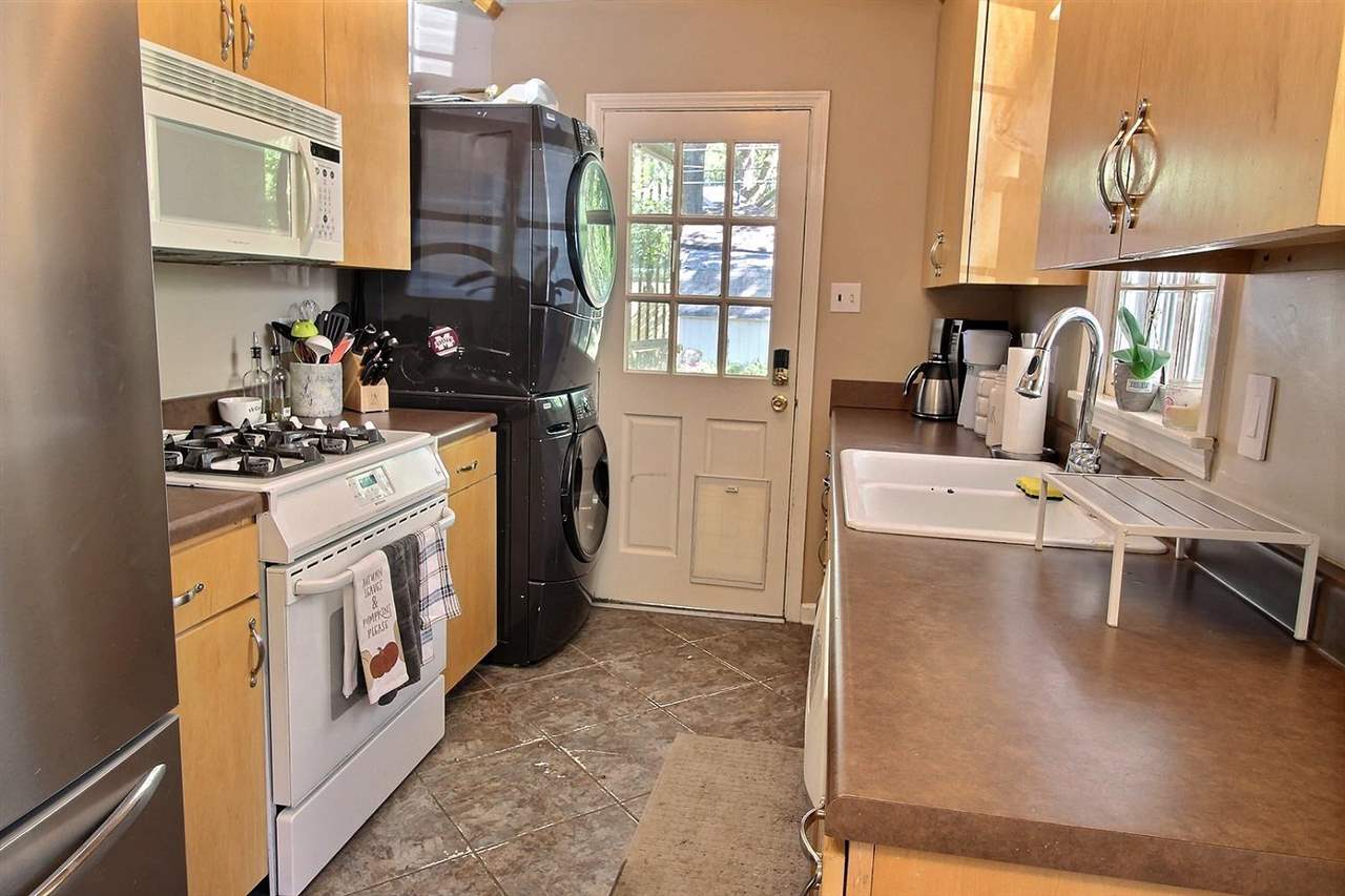 1654 Colonial Road Memphis, TN 38117 - Photo 9 of 14 a kitchen with stainless steel appliances granite countertop a stove a sink and a refrigerator