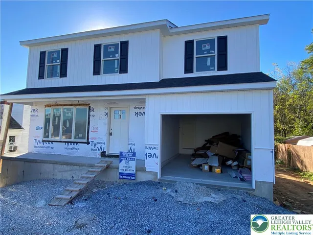 a view of living room with furniture and a fireplace