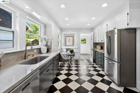a kitchen with a refrigerator a sink and a window