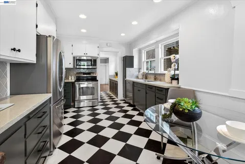 a kitchen with stainless steel appliances granite countertop a sink and a stove