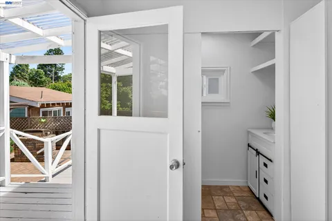 hallway with wooden floor and windows