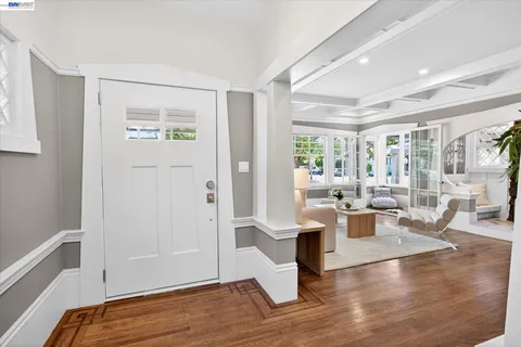 a living room with furniture wooden floor and a large window