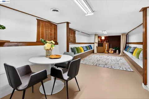 a living room with furniture and a dining table