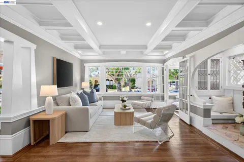 a living room with fireplace furniture and a large window