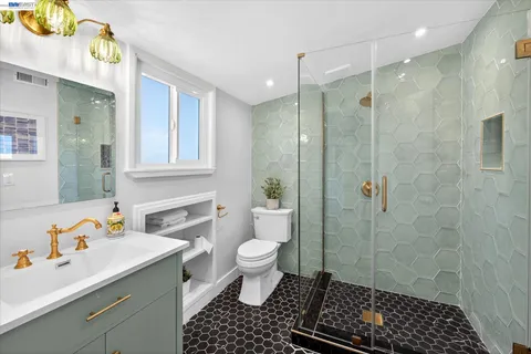 a bathroom with a sink toilet and shower