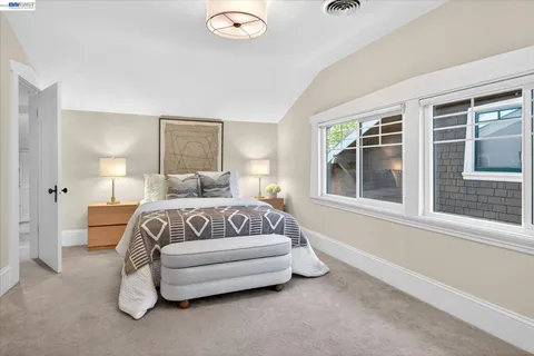 a spacious bedroom with a bed and glass window