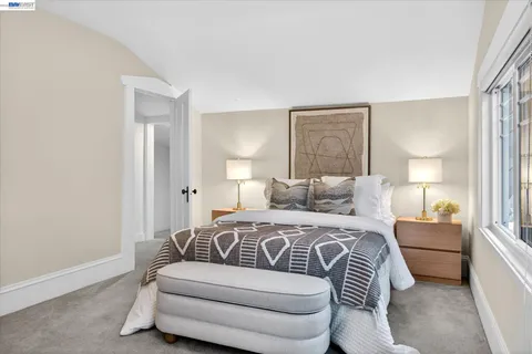 a bedroom with a bed and a couch