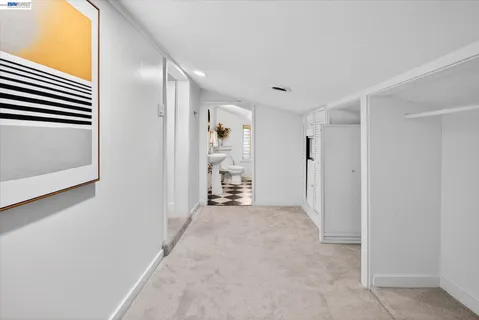 a view of a big room with closet and windows