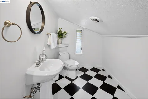 a bathroom with a toilet a sink and a mirror