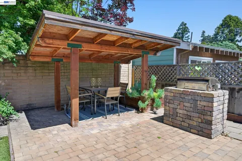 a patio with table and chairs