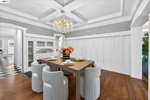 a view of a dining room with furniture wooden floor and chandelier