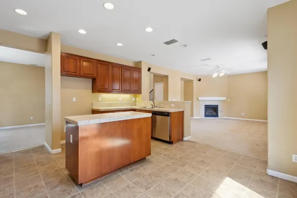 a large kitchen with stainless steel appliances granite countertop a large counter top and a stove top oven