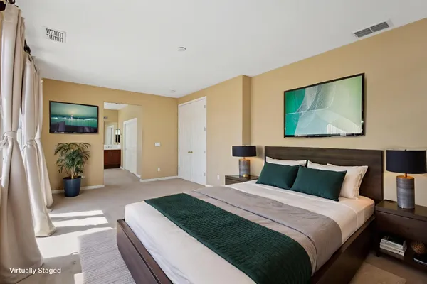 a bedroom with bed and glass door