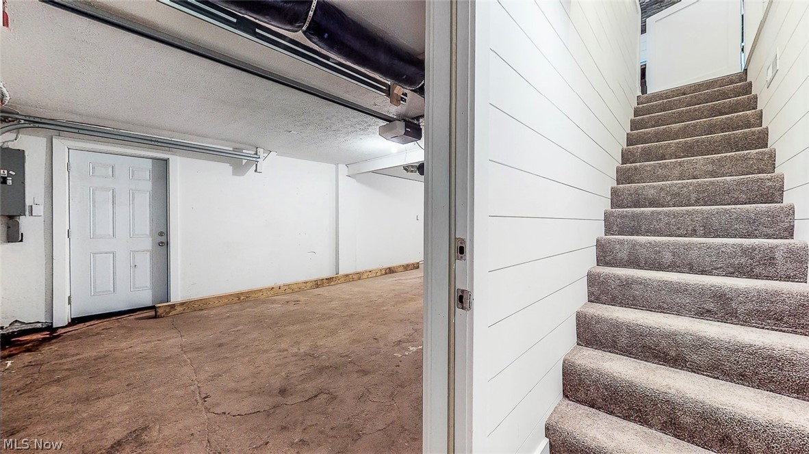 2152 McCoy Road Akron, OH 44320 - Photo 26 of 32 *1.5 CAR GARAGE ATTACHED WITH MAN DOOR AND NEW CARPETED/SHIPLAPPED STAIRWAY TO THE FIRST FLOOR ~