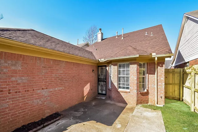 a white bath tub with a shower and a toilet