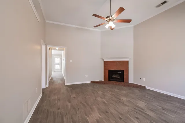 an empty room with windows and a fireplace