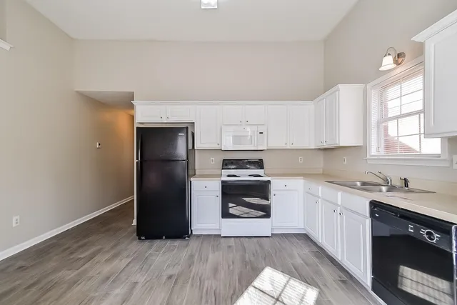 a kitchen with a refrigerator stove and sink