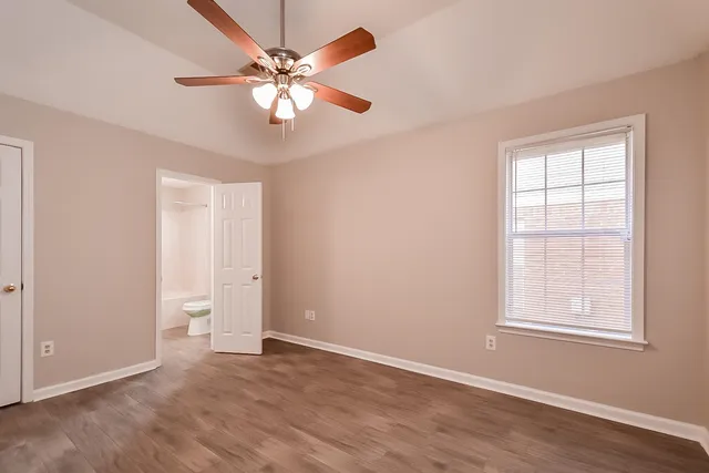 a kitchen with a refrigerator and a stove top oven