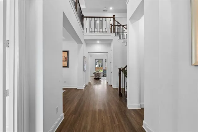a view of entryway and hall with wooden floor